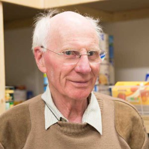 An elderly male foodbank volunteer