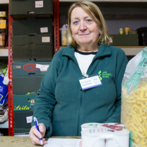 Foodbank volunteer with large bag of pasta