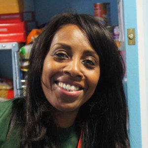 A female foodbank volunteer with food in the background