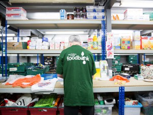 A volunteer sorts foodbank donations in the Midlands