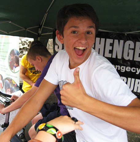 Young cyclist gives a thumbs up on a fundraising ride