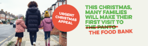 Banner with woman and her two children on a street with their backs to the camera. Text reads "Urgent Christmas Appeal. This Christmas many families will make their first visit to the panto," with the panto crossed out and replaced with "the food bank."