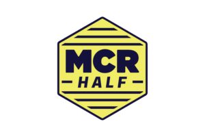Manchester Half Marathon logo. The logo is yellow and navy blue with the text 'MCR Half'.